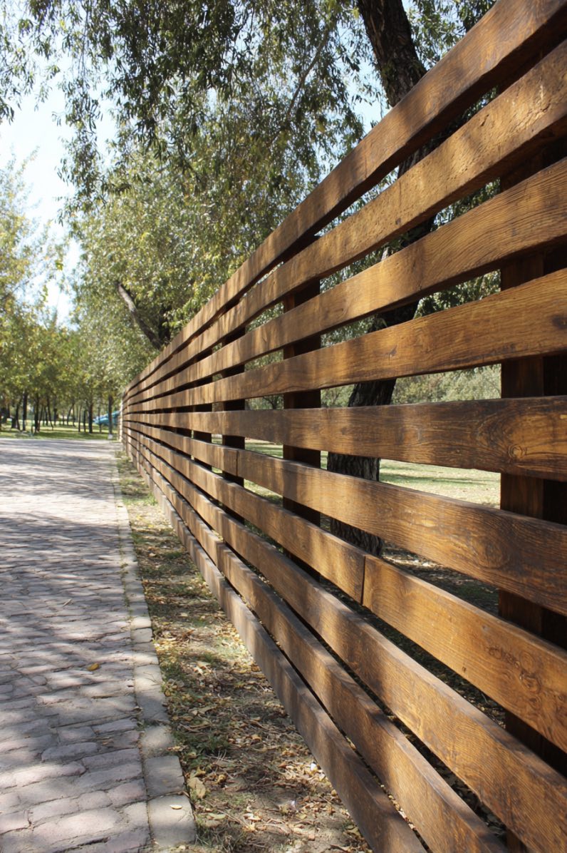 Angled wooden fence with thick horizontal slats